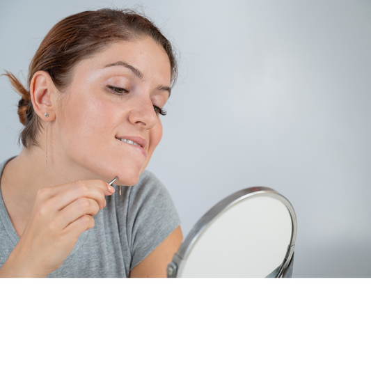 A woman plucking facial hair PCOS skin issue